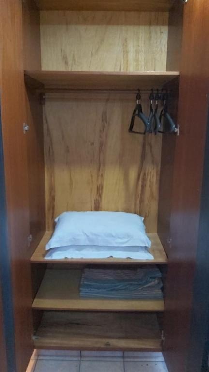 a wooden shelf with a bed in a room at Pousada dos Girassóis in Palmas