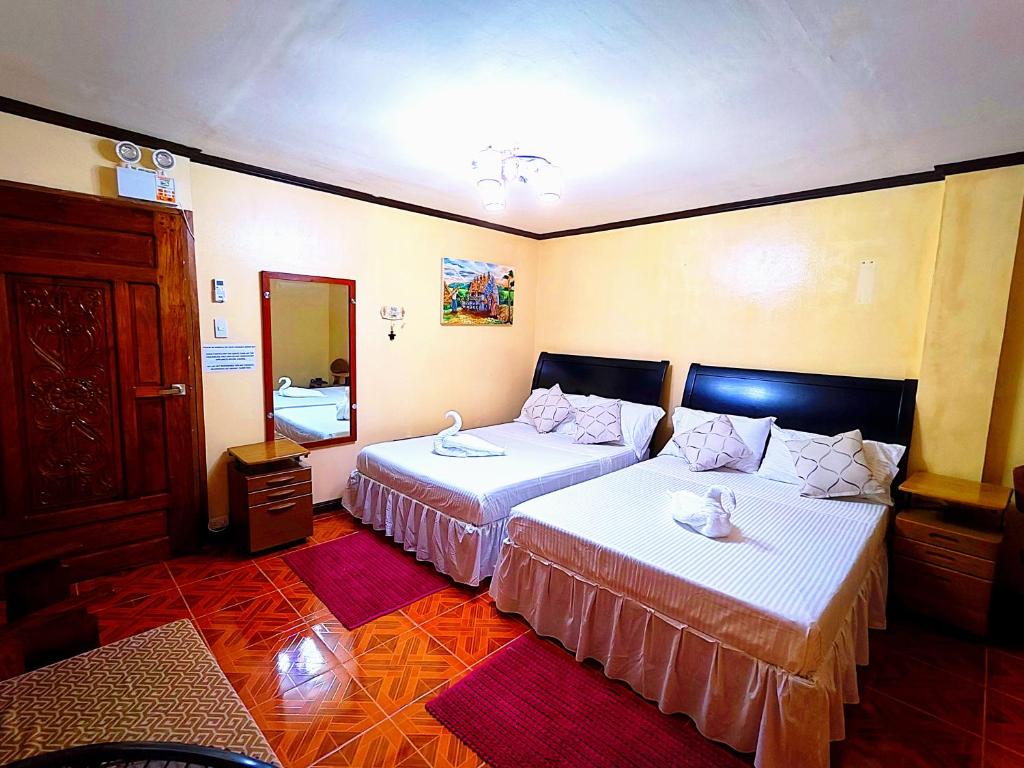 Postel nebo postele na pokoji v ubytování Evan's Homestay