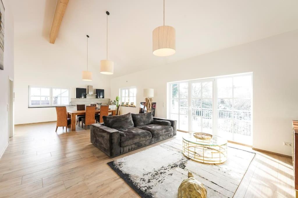 a living room with a couch and a table at Loft “Samuel” in Utting am Ammersee