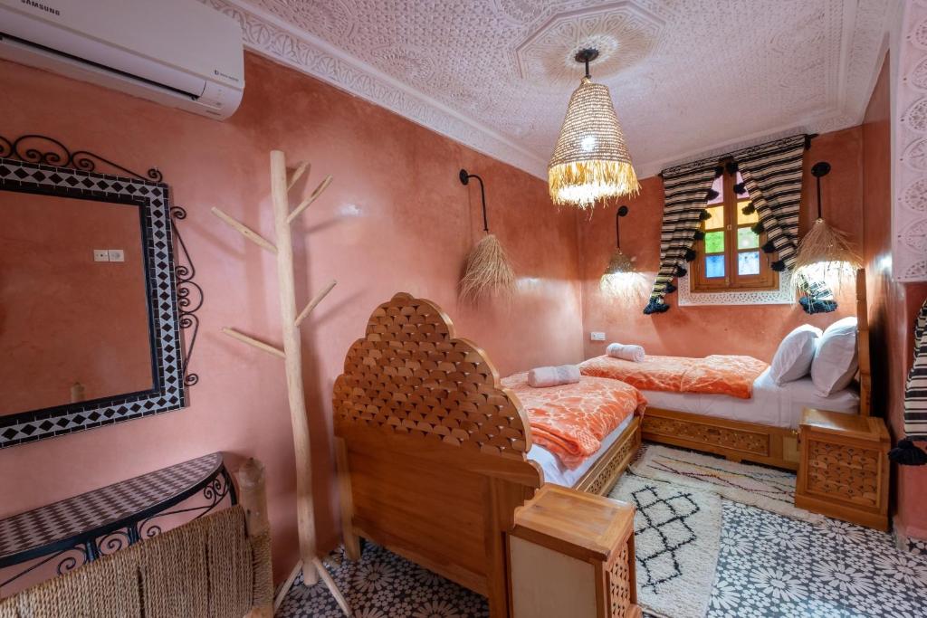 Cama ou camas em um quarto em Riad Mosaic
