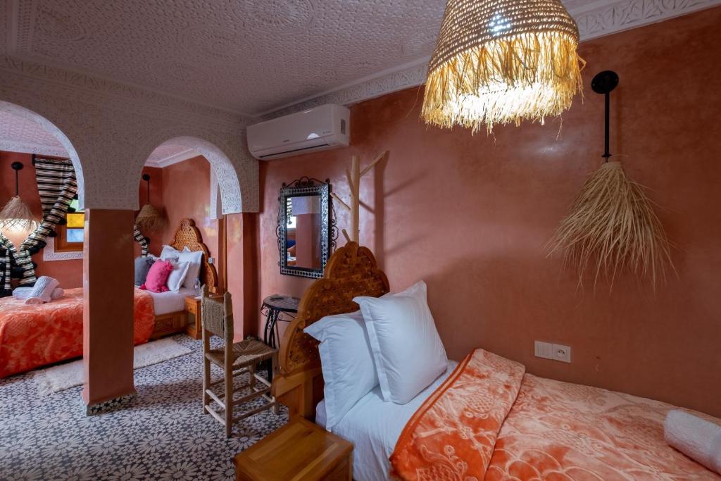 Cama ou camas em um quarto em Riad Mosaic