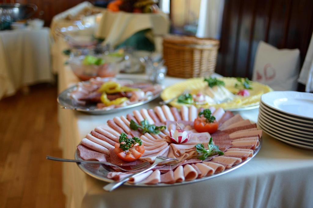 a table with plates of food on top of it at Alpengasthof zur Post in Schattwald