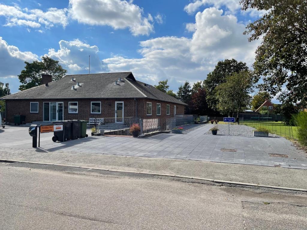 a brick house with a parking lot in front of it at Nordkap Bed & Bath in Holstebro