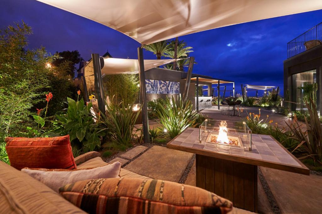a patio with a couch and a fire pit at Les Suites at The Cliff Bay - PortoBay in Funchal