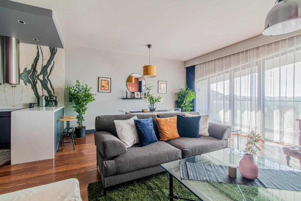 a living room with a couch and a glass table at Centrally Located Flat with Balcony in Beyoglu in Istanbul