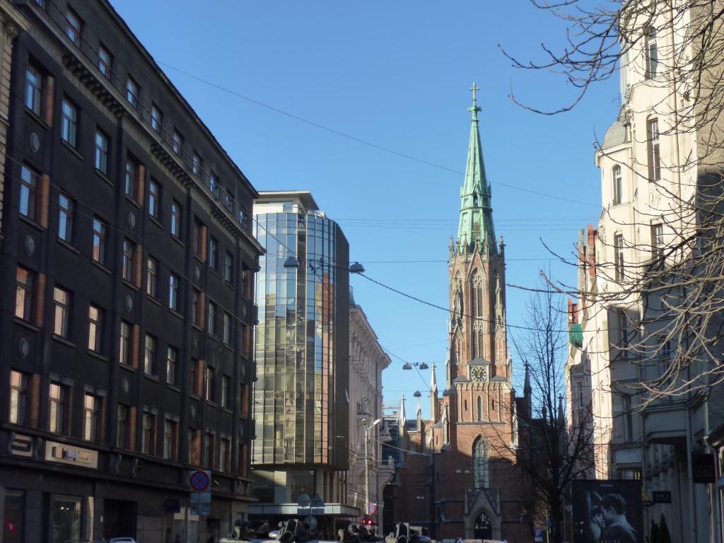 a tall church steeple in a city with buildings at ANNA Riga Apartment in Riga