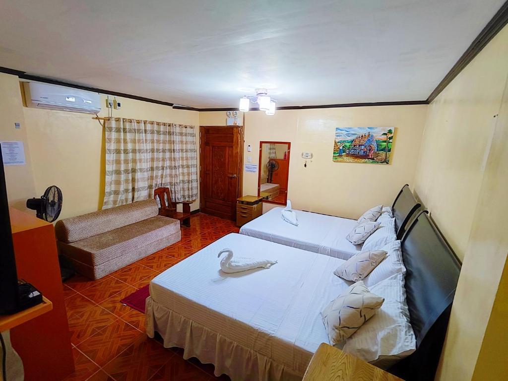 Postel nebo postele na pokoji v ubytování Evan's Homestay