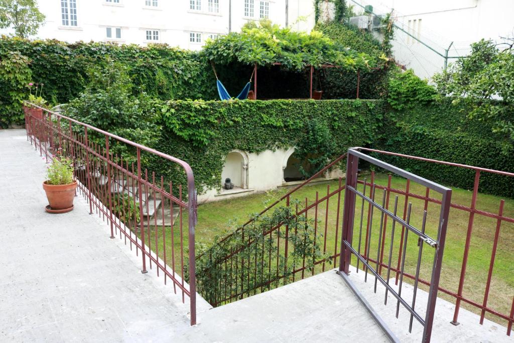 a metal railing next to a garden with plants at Sky Accommodations Studio 2 in Coimbra