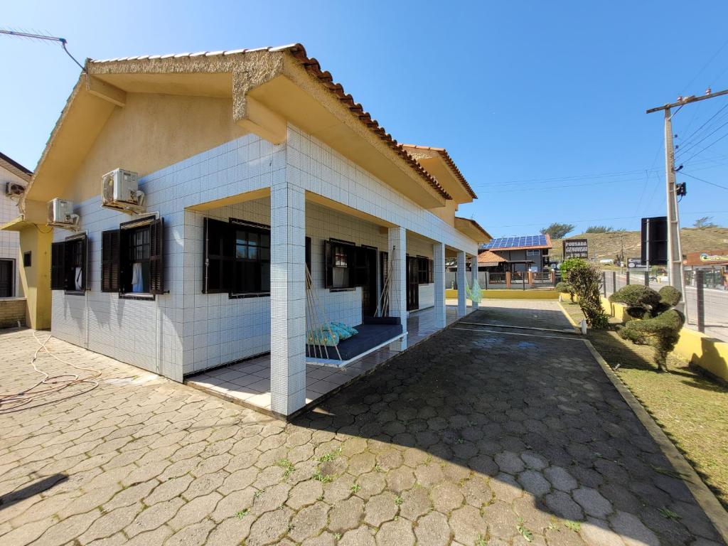 a house with a driveway in front of it at Pousada Genoveva - Casa a beira mar in Laguna