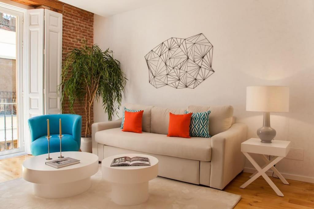 a living room with a couch and a chair at Apartment a few steps from Puerta del Sol in Madrid
