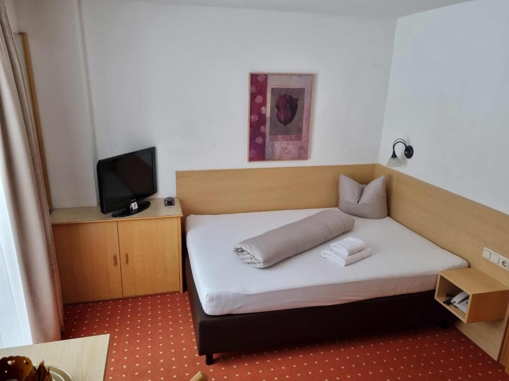 Ένα ή περισσότερα κρεβάτια σε δωμάτιο στο Hotel Garni Corinna