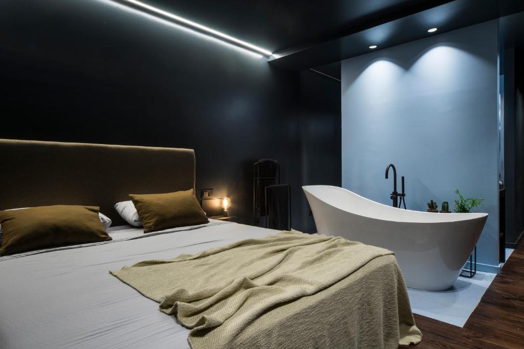a bedroom with a bed and a bath tub at Lava in Donostia-San Sebastián