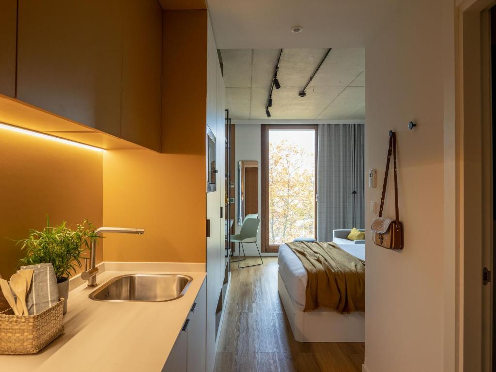 A bed or beds in a room at Kora Green City - Aparthotel Passivhaus