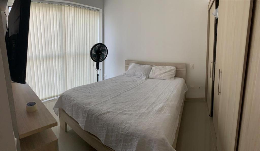 Apartamentos Amoblados tesisinde bir odada yatak veya yataklar