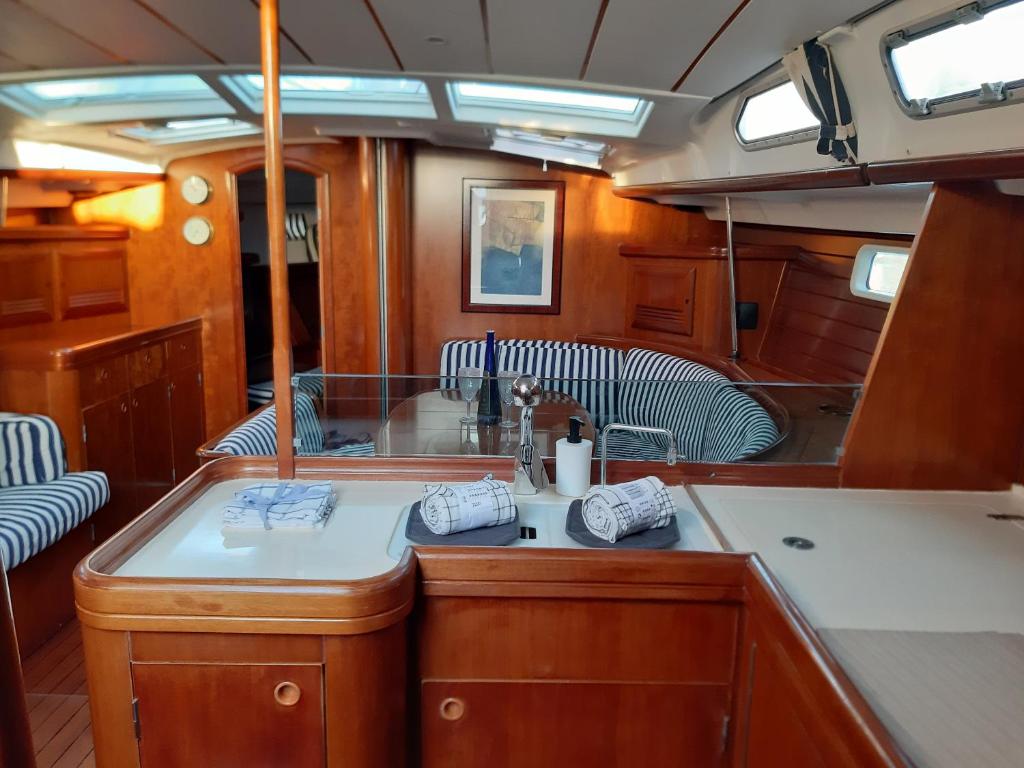 a kitchen with a sink and chairs in a boat at Erima in Puerto Calero