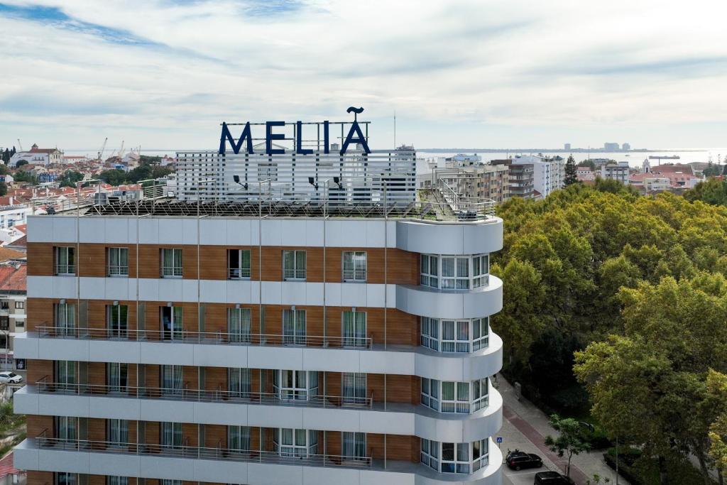a building with a meena sign on top of it at Melia Setubal in Setúbal