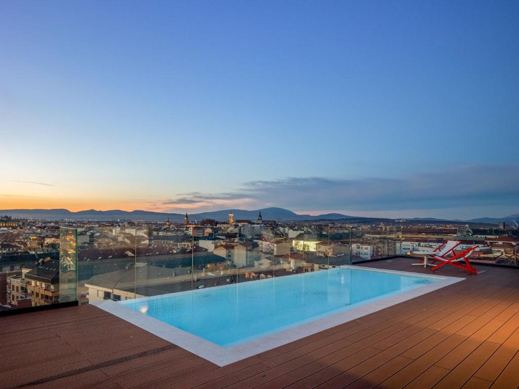 a swimming pool on the roof of a building at Kora Green City - Aparthotel Passivhaus in Vitoria-Gasteiz
