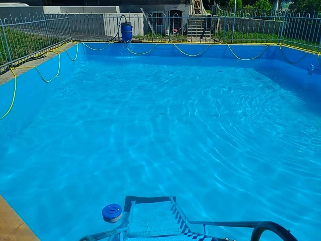 a large blue swimming pool with blue water at Friedlis Buurehof in Affoltern