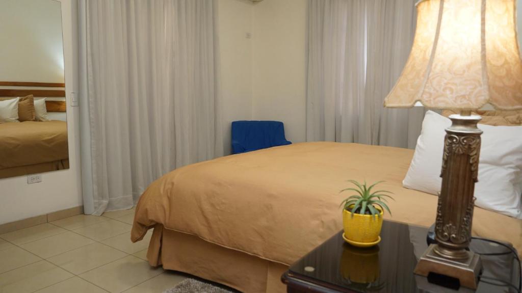 Postel nebo postele na pokoji v ubytování Hotel Casa del Arbol