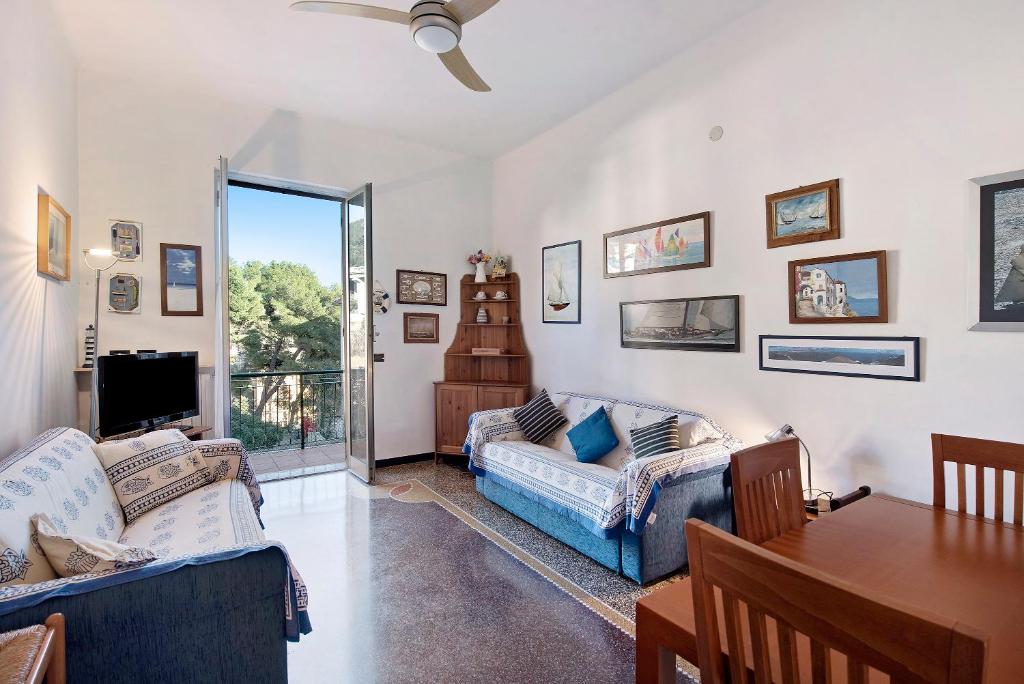 a living room with two couches and a table at Casa Europa - Arenzanohost in Arenzano