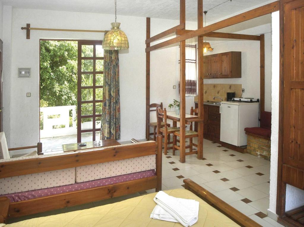 a kitchen and living room with a large window at Proimos Apartments in Gerani