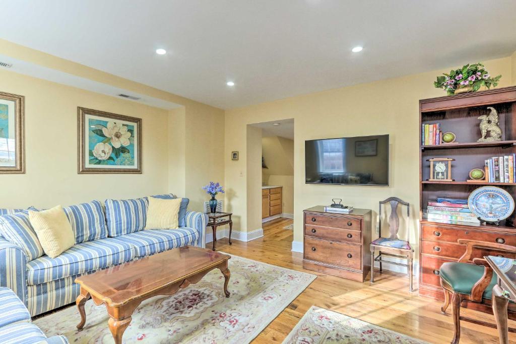 a living room with a couch and a tv at Townhome in Leesburg Historic District! in Leesburg