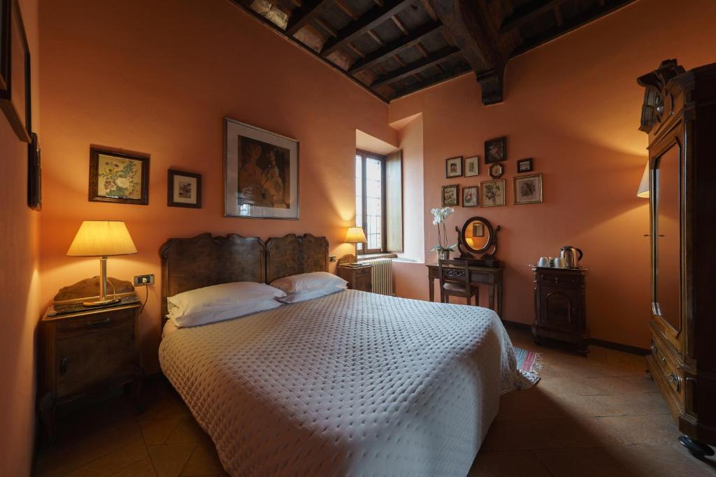 a bedroom with a bed with a white bedspread at Castello di Cernusco Lombardone in Cernusco Lombardone