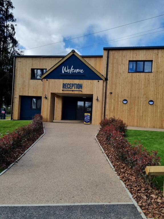 a building with a sign that reads welcome reception at Bungalow 62,North Cornwall, St. Tudy in Saint Tudy