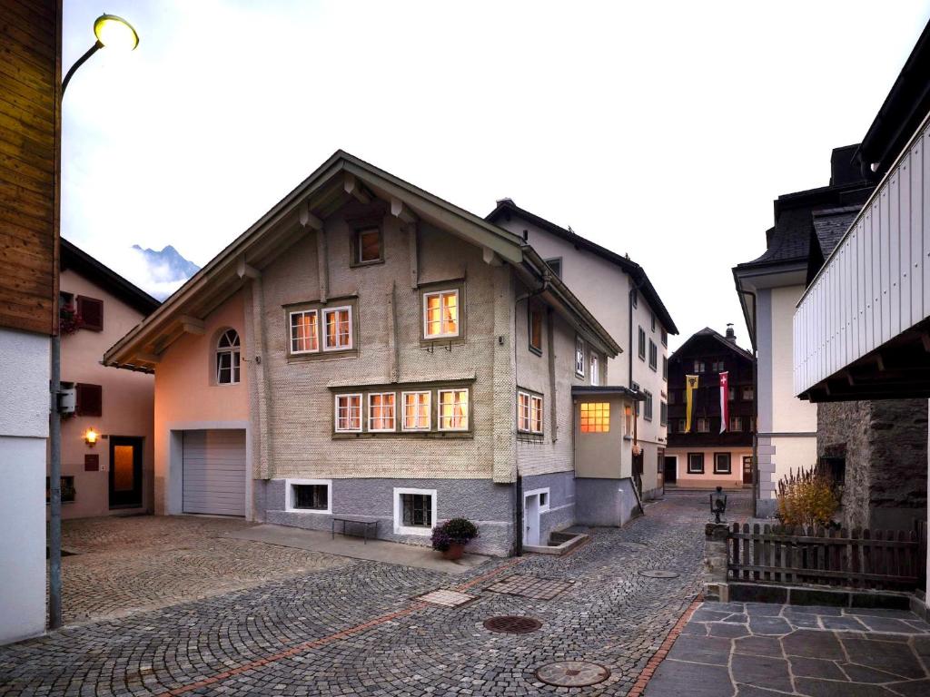 an old house is sitting on a cobblestone street at Charming Swiss Chalet Andermatt in Andermatt
