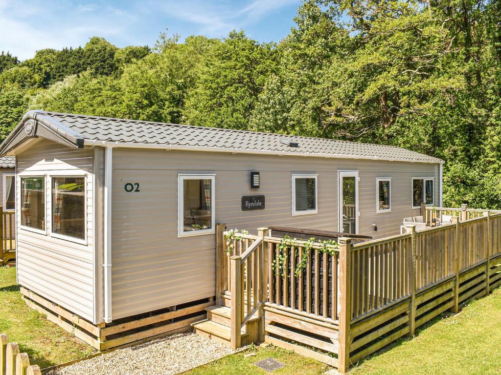 a tiny house with a deck in a yard at Nice Cottage In Ilfracombe With 3 Bedrooms And Wifi in Ilfracombe