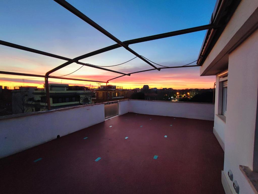 a balcony with a view of a sunset at Attico Sea and Sunset in Lido di Ostia