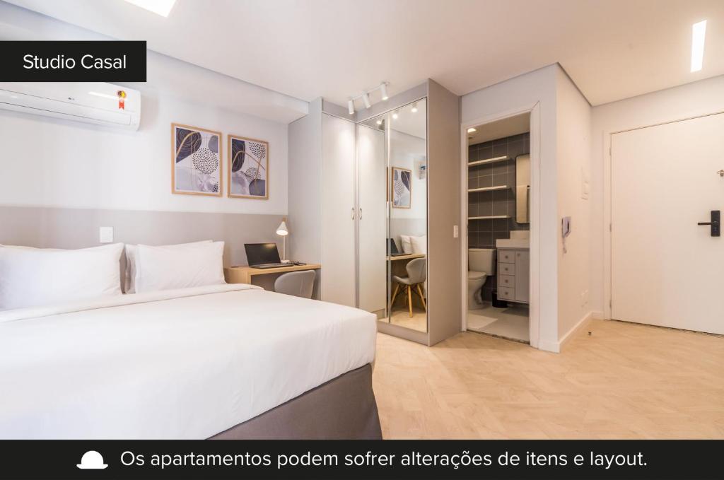 a bedroom with a white bed and a room with a desk at Smart Charlie Mobi Pinheiros in Sao Paulo