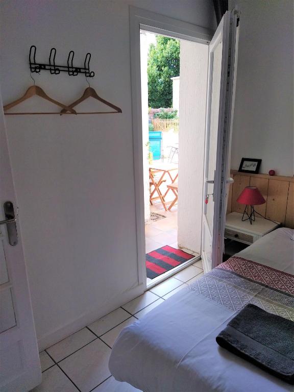 a bedroom with a bed and a door leading to a patio at Les Gîtes d&#39;Angres - gîte n°1 in Angres