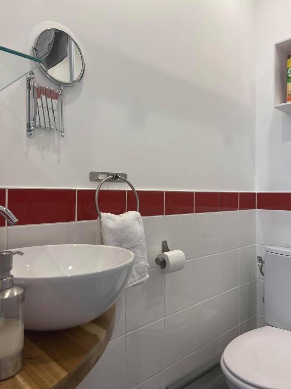 a bathroom with a white sink and a toilet at Les Gîtes d&#39;Angres - gîte n°1 in Angres