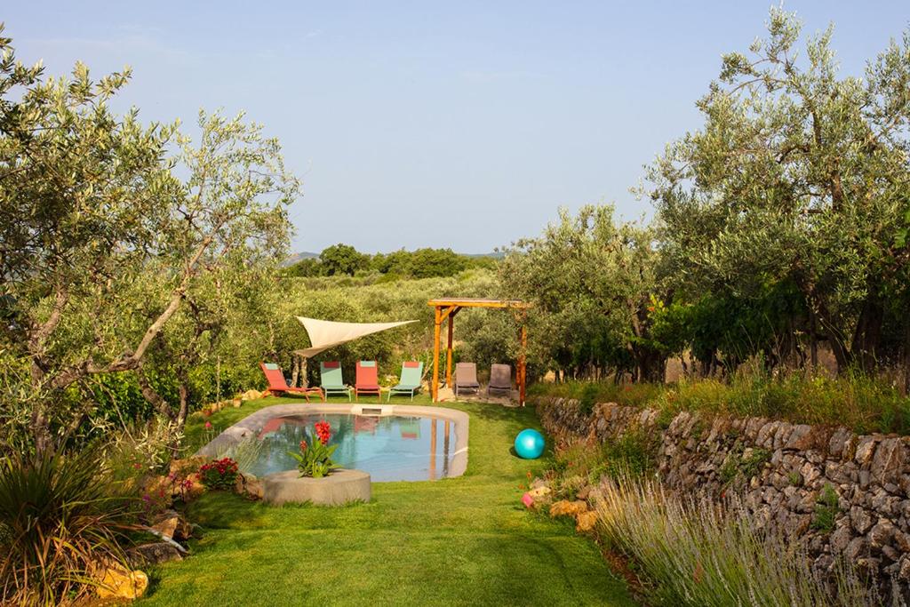 a backyard with a swimming pool in the grass at Rietine24 in Gaiole in Chianti