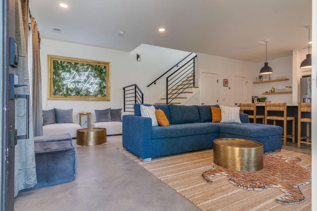 a living room with a blue couch and a table at The Alessia - Downtown Luxury in Gated Community in Nashville