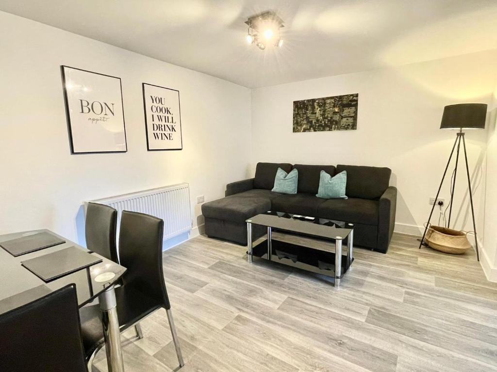 a living room with a couch and a table at *Modern & Stylish 2 Double Bedroom-Free Parking!* in Bristol