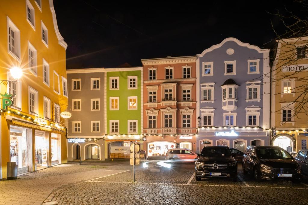 uma rua da cidade à noite com carros estacionados em frente aos edifícios em Loft Suite im modernen Style in Schärding em Schärding