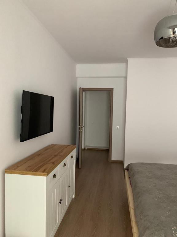 a bedroom with a bed and a flat screen tv at HAPPY SUMMER -Predeal in Predeal