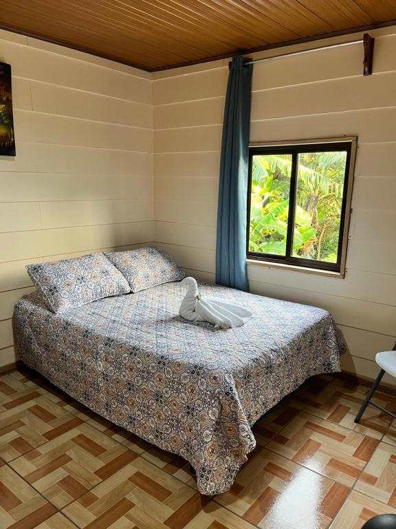 a bedroom with a bed and a window at Bonanza in Monteverde Costa Rica
