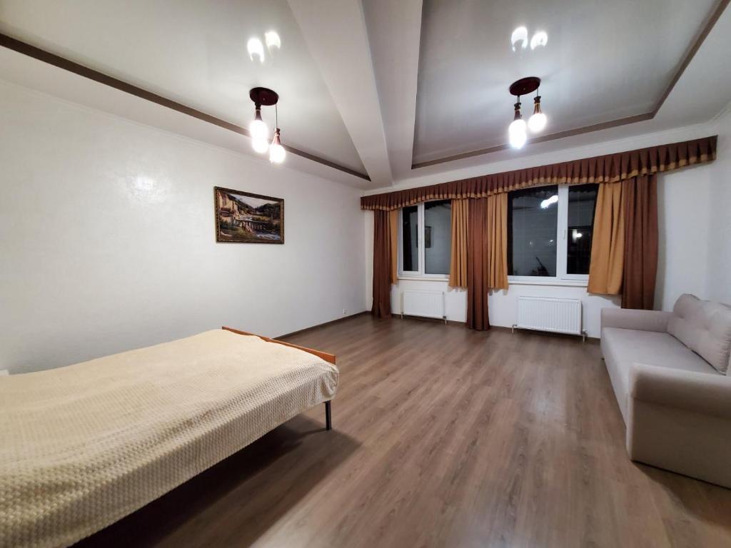 a bedroom with a bed and a couch in a room at Guest house in Uman