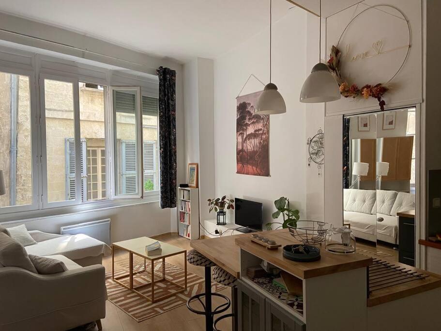 a living room with a couch and a table in it at Loft hyper centre in Avignon