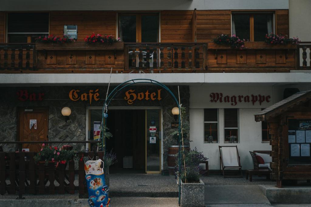 a building with a sign that reads caffe sobel at Hôtel Magrappé in Veysonnaz