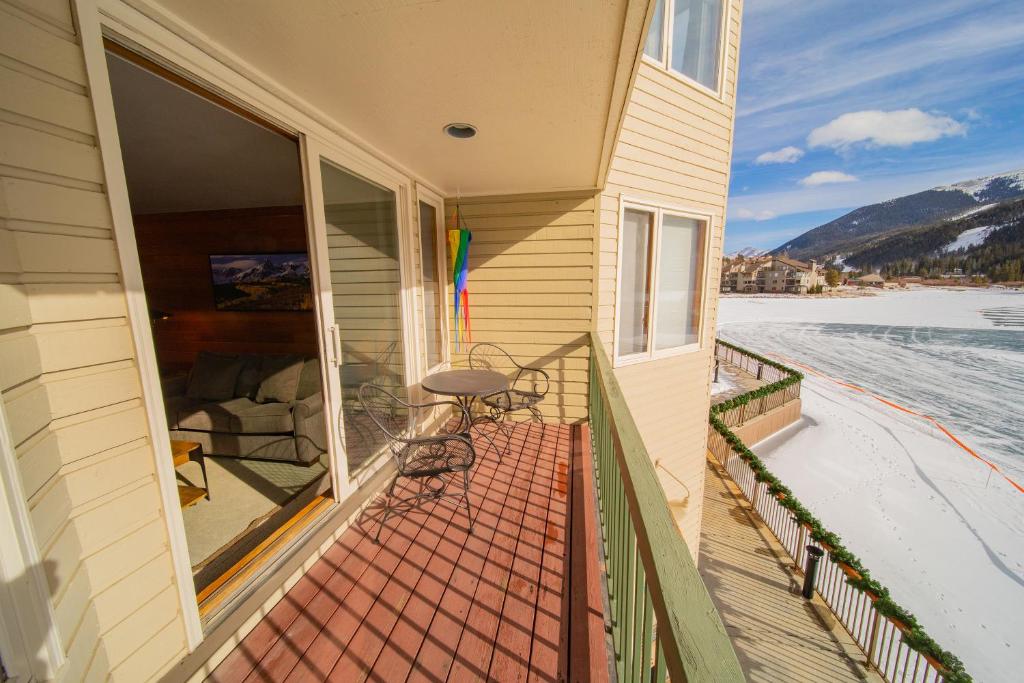 a balcony of a house with a table and chairs at Lakeside 1476 in Keystone