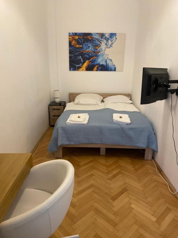 a bathroom with a bed and a bath tub at Neuhausz Residenz Ultra-Central Apartment in Timişoara