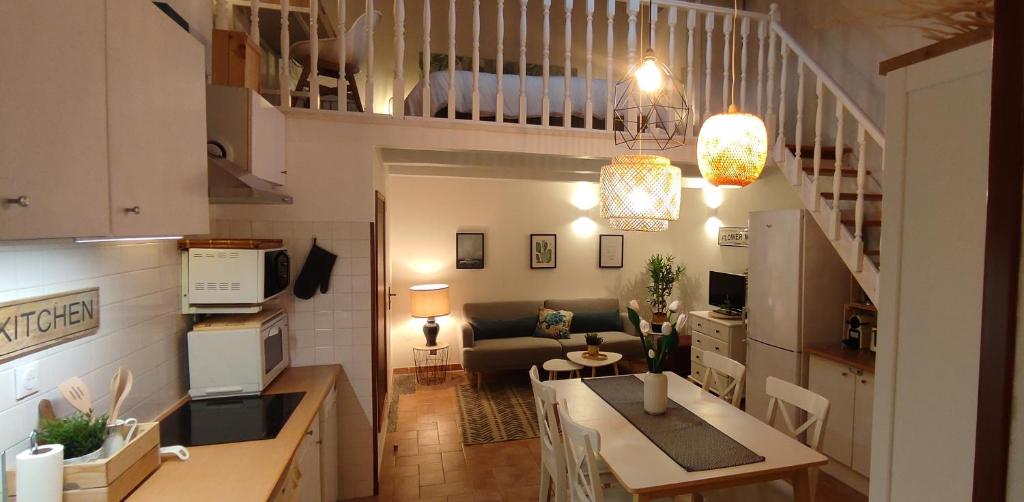 a kitchen and living room with a table and a couch at Chill Out Cabanon Coeur Calanques in Marseille