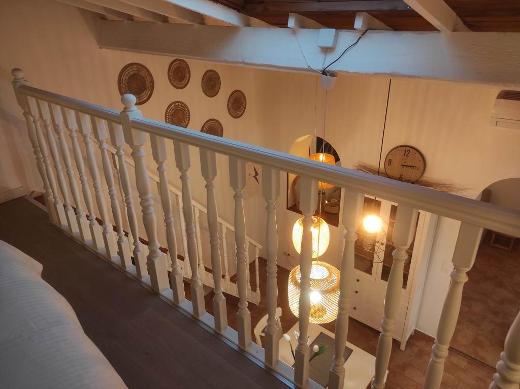 a stair railing with a clock on the wall at Chill Out Cabanon Coeur Calanques in Marseille