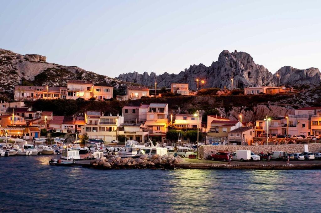 a group of houses and boats in a harbor at Chill Out Cabanon Coeur Calanques in Marseille
