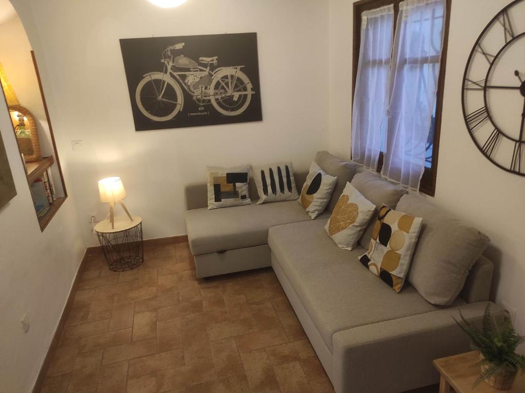 a living room with a couch and a bike on the wall at Chill Out Cabanon Coeur Calanques in Marseille