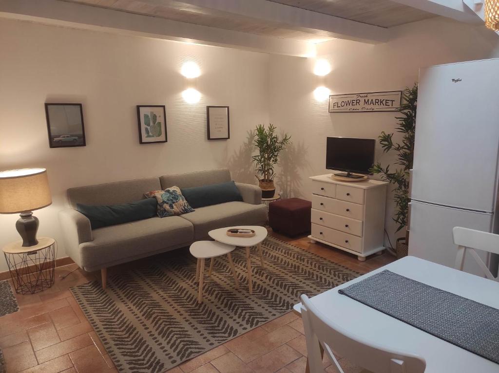a living room with a couch and a tv at Chill Out Cabanon Coeur Calanques in Marseille
